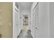 Hallway view to the kitchen with tile floors and built in storage cabinets at 243 Cherokee Ct, Brighton, CO 80603
