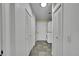 Hallway laundry with stacked washer and dryer and ample closet space at 243 Cherokee Ct, Brighton, CO 80603