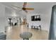 Open-concept living room featuring a large ceiling fan and light tile flooring at 243 Cherokee Ct, Brighton, CO 80603