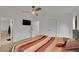This main bedroom features a ceiling fan and access to the ensuite bathroom at 243 Cherokee Ct, Brighton, CO 80603