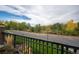 Balcony view overlooking a street, lush landscaping and mature trees and greenery at 6000 W Floyd Ave # 107, Denver, CO 80227