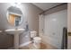 Cozy bathroom featuring a pedestal sink, toilet, and a clean, bright bathtub with a shower at 6000 W Floyd Ave # 107, Denver, CO 80227