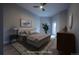 Comfortable bedroom with warm lighting, sleek furniture, and a stylish ceiling fan at 6000 W Floyd Ave # 107, Denver, CO 80227