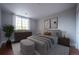 Serene bedroom with a comfortable bed, soft neutral tones, and a bright window with decorative curtains at 6000 W Floyd Ave # 107, Denver, CO 80227