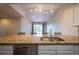 Open kitchen island with a granite countertop and stainless steel sink, perfect for entertaining and dining at 6000 W Floyd Ave # 107, Denver, CO 80227