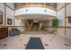 Elegant building lobby featuring a staircase, wood trim, tiled floor and comfortable seating at 6000 W Floyd Ave # 107, Denver, CO 80227