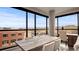 Bright dining area with scenic views and a wooden table is lit by a contemporary ceiling light at 20 Wilcox St # 302, Castle Rock, CO 80104