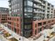 Aerial view of a modern mixed-use building with retail and residential spaces at 20 Wilcox St # 302, Castle Rock, CO 80104