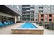 Relaxing outdoor pool with lounge chairs and tables, surrounded by modern architecture at 20 Wilcox St # 302, Castle Rock, CO 80104