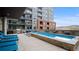 Inviting pool with lounge chairs overlooking a great view and modern building at 20 Wilcox St # 302, Castle Rock, CO 80104