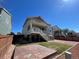 Beautifully landscaped backyard with a patio, fenced area, garden beds and a staircase leading to the deck at 1055 Snowberry Ave, Elizabeth, CO 80107