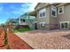 Well-manicured backyard featuring rock landscaping, healthy lawn and stairway to rear deck at 1055 Snowberry Ave, Elizabeth, CO 80107