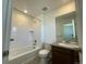 Bright bathroom featuring a vanity with sink, toilet, and a tub/shower combo with tile surround at 1055 Snowberry Ave, Elizabeth, CO 80107