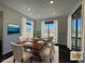 Dining room with a wooden table and seating for six, adjacent to sliding glass doors at 1055 Snowberry Ave, Elizabeth, CO 80107