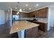 Modern kitchen with stainless steel appliances, granite countertops, and center island at 1055 Snowberry Ave, Elizabeth, CO 80107