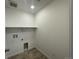 A utility room with tile flooring and hookups for a washer and dryer at 1055 Snowberry Ave, Elizabeth, CO 80107