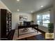 This office includes a large desk, dark wood floors, large bookcase, and a bright sunny window at 1055 Snowberry Ave, Elizabeth, CO 80107