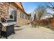Backyard with stone house, patio with grill, and outdoor seating area at 2958 S Lisbon Way, Aurora, CO 80013