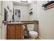 Comfortable bathroom featuring a toilet and vanity with wood cabinets at 2958 S Lisbon Way, Aurora, CO 80013