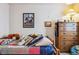 Charming bedroom featuring a quilt blanket, stuffed animals and a rustic dresser at 2958 S Lisbon Way, Aurora, CO 80013