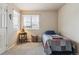 Cozy bedroom with natural light, quilt blanket, and a bedside table with a lamp at 2958 S Lisbon Way, Aurora, CO 80013