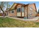 Charming exterior with stone accents, manicured lawn, and well-maintained landscaping at 2958 S Lisbon Way, Aurora, CO 80013
