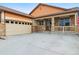 Charming home with stone accents, front porch, attached garage, and driveway at 2958 S Lisbon Way, Aurora, CO 80013