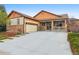 Charming home with stone accents, front porch, attached garage, and driveway at 2958 S Lisbon Way, Aurora, CO 80013