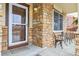 Charming front porch with brick accents and seating area at 2958 S Lisbon Way, Aurora, CO 80013
