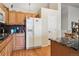 Bright kitchen with wood cabinets, granite countertops, and stainless refrigerator at 2958 S Lisbon Way, Aurora, CO 80013