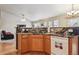 Open kitchen with wood cabinets, stainless appliances, granite countertops, and hardwood floors at 2958 S Lisbon Way, Aurora, CO 80013