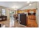 Open kitchen with wood cabinets, stainless appliances, granite countertops, and hardwood floors at 2958 S Lisbon Way, Aurora, CO 80013