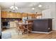 Bright kitchen featuring wooden cabinets, granite countertops, and an adjacent breakfast nook with a round table at 2958 S Lisbon Way, Aurora, CO 80013