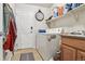 Functional laundry room with a washer, dryer, and storage shelves at 2958 S Lisbon Way, Aurora, CO 80013