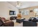 Comfortable living room with vaulted ceiling, plush sofas, a ceiling fan, and a large TV for entertainment at 2958 S Lisbon Way, Aurora, CO 80013