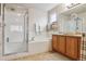 Well-lit main bathroom with a glass-enclosed shower and separate soaking tub at 2958 S Lisbon Way, Aurora, CO 80013