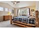 Inviting bedroom with vaulted ceiling, soft natural light, and rustic log-style bed for a cozy and serene retreat at 2958 S Lisbon Way, Aurora, CO 80013