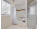 Bathroom featuring a tub/shower combination, safety bars, and a glass-enclosed shower stall at 6444 Silver Mesa Dr # A, Highlands Ranch, CO 80130
