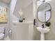 Tastefully decorated powder room with modern fixtures, stylish mirror, and artistic details at 6444 Silver Mesa Dr # A, Highlands Ranch, CO 80130