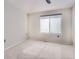 Bright bedroom with neutral carpet, gray window shade, and base trim at 6444 Silver Mesa Dr # A, Highlands Ranch, CO 80130