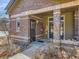 Inviting entrance featuring brick accents, neutral siding, and well-defined unit number above the door for easy identification at 6444 Silver Mesa Dr # A, Highlands Ranch, CO 80130