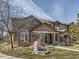 Charming two-story home featuring brick and neutral siding, complemented by a well-maintained lawn and inviting entrance at 6444 Silver Mesa Dr # A, Highlands Ranch, CO 80130