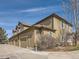 Exterior view of the property showcasing garage, house number, and a well kept landscape at 6444 Silver Mesa Dr # A, Highlands Ranch, CO 80130