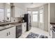 Well lit kitchen featuring a stainless steel refrigerator, white cabinets, and ample counter space at 6444 Silver Mesa Dr # A, Highlands Ranch, CO 80130
