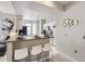 Modern kitchen with sleek white cabinetry, stainless steel appliances, and a convenient breakfast bar for casual dining and entertaining at 6444 Silver Mesa Dr # A, Highlands Ranch, CO 80130