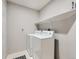 Laundry room has a washer, dryer, and shelving for storage and organization at 6444 Silver Mesa Dr # A, Highlands Ranch, CO 80130