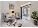 Inviting sitting area with comfortable chairs, stylish accents, and a large sliding glass door leading to an outdoor space at 6444 Silver Mesa Dr # A, Highlands Ranch, CO 80130