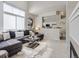 Bright and airy living room boasts a modern sectional sofa, stylish decor, and seamless flow into the adjacent kitchen at 6444 Silver Mesa Dr # A, Highlands Ranch, CO 80130
