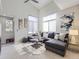 Bright living room with vaulted ceilings, modern decor, a plush sectional, and plenty of natural light from large windows at 6444 Silver Mesa Dr # A, Highlands Ranch, CO 80130