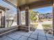 Covered front patio with brick columns offering curb appeal and a place to relax at 6444 Silver Mesa Dr # A, Highlands Ranch, CO 80130